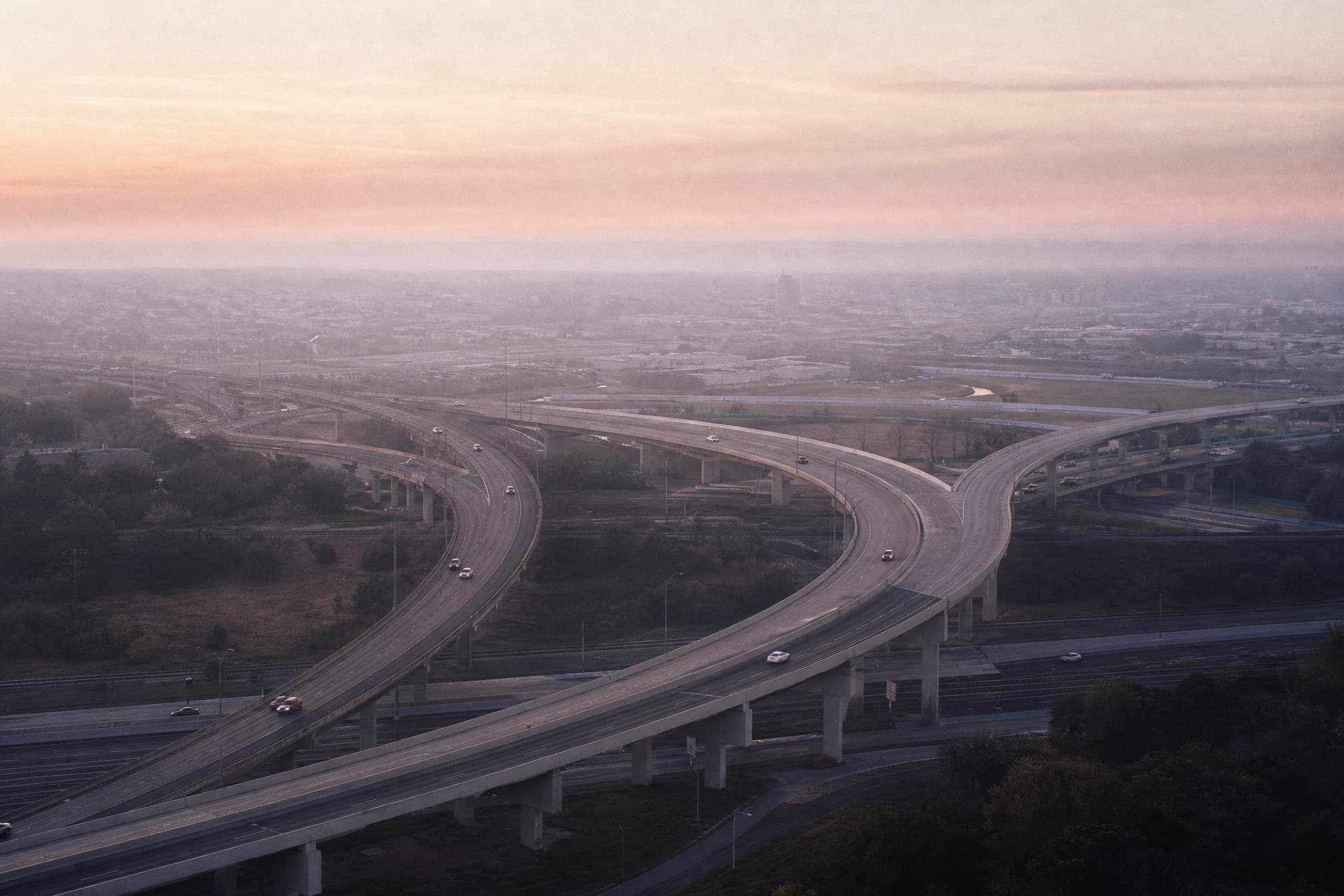 Aerial view of a highway interchange at dawn — the accident corridors where motor vehicle accident cases begin